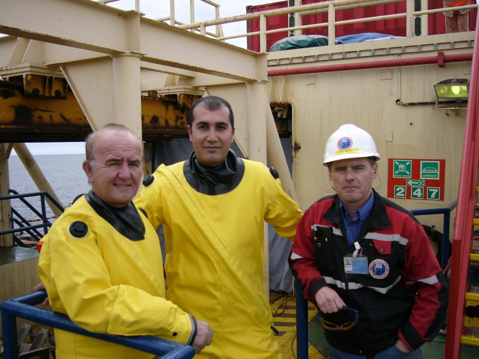 Ehab Abutahoun in an offshore survival suit with two colleagues aboard a pipelay barge